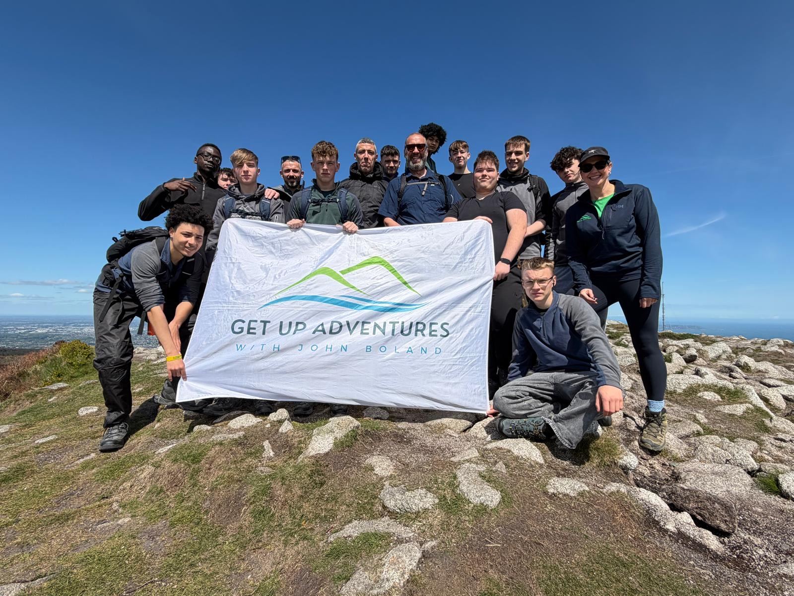 Youth group with the flag on a summit